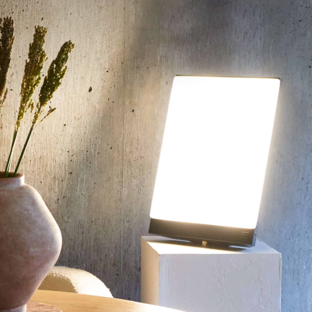 BOXelite desk lamp illuminating a modern workspace in warm morning light